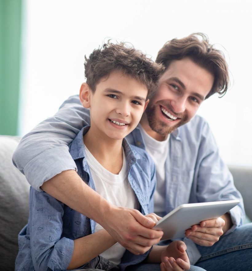 family-time-happy-dad-and-son-using-digital-tablet-browsing-internet-online-at-home-sitting-e1632233068896-pf2n5jejt9mlkmkxp4dapq9m1q6wt3nupjwyt2d6cg